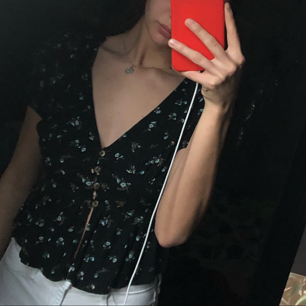 selling shirt and white jeans